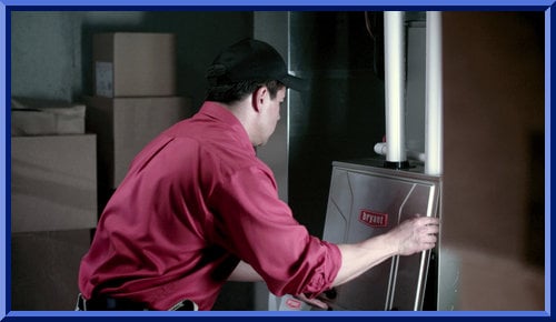 Worker performing furnace maintenance