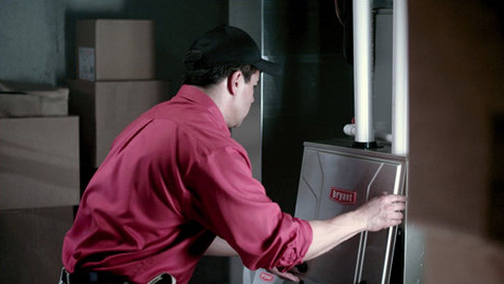 Worker performing furnace maintenance