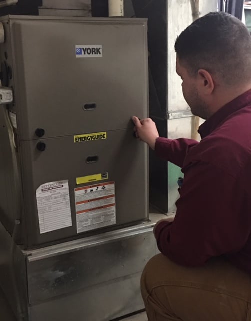 Technician repairing a heating system